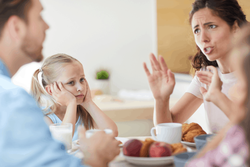 woman stressed out with her family at the table